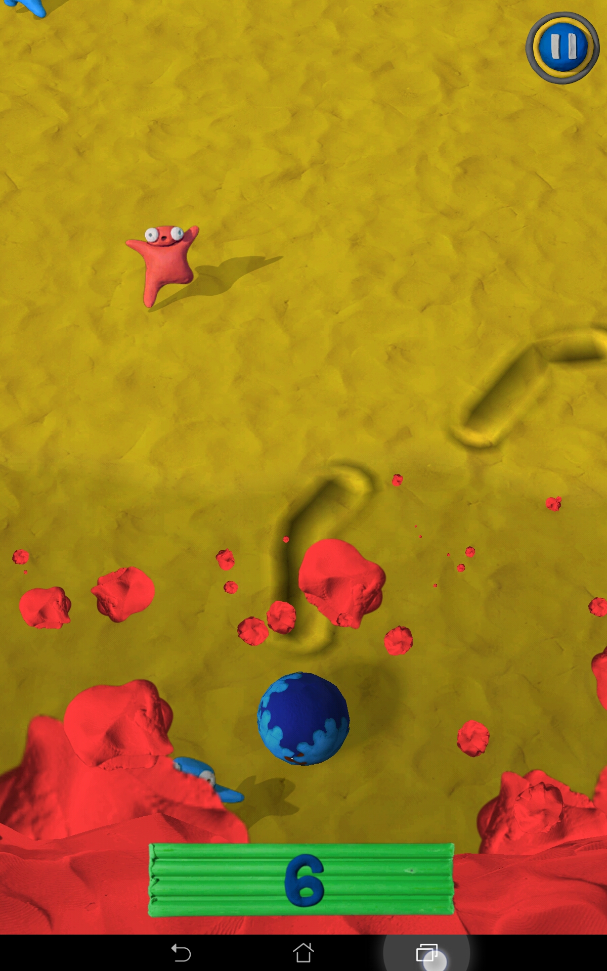 Clay Jam in game screenshot, where trenches dug with fingers guide the ball that will squish clay monsters to progress, while a red wave of clay indicates the player is about to lose and needs to move faster.